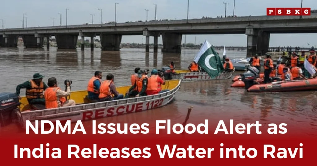 Rescue boats with people in orange vests navigate a flooded river under a bridge, a Pakistani flag waving nearby, during the Pakistan Flood Alert Ravi issued by NDMA.