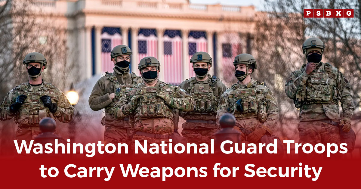 Six National Guard troops in uniform and masks stand in front of a building with U.S. flags, representing the National Guard armed deployment Washington D.C. for security.