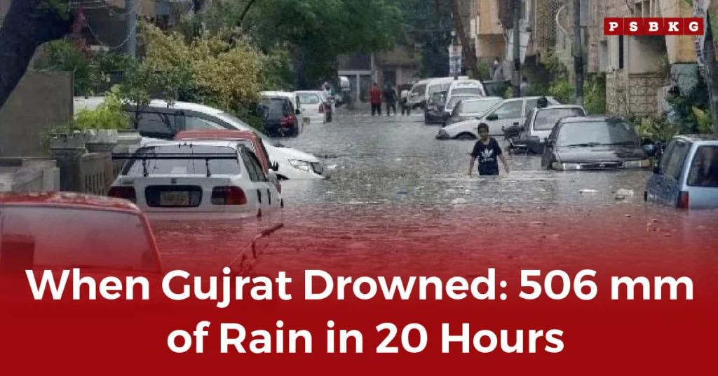 A flooded street in Gujrat, with cars submerged and people wading through deep water after the Gujrat flood rainfall 506mm hit the city.