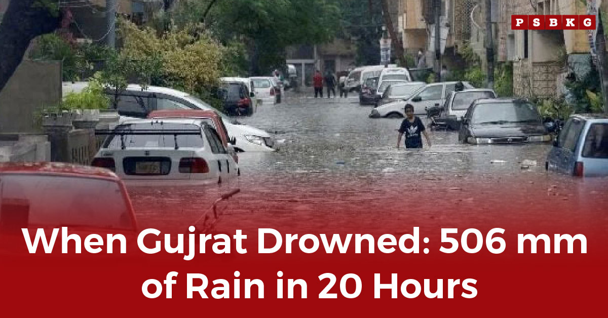 A flooded street in Gujrat, with cars submerged and people wading through deep water after the Gujrat flood rainfall 506mm hit the city.