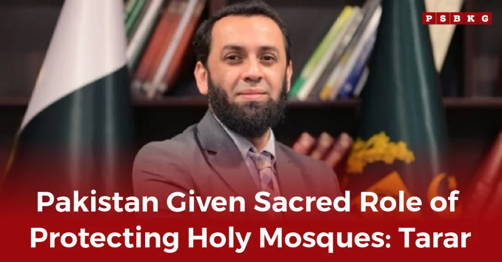 A man in a suit stands before shelves of books beside the Pakistani flag, discussing Pakistan’s role in Holy Mosques protection.