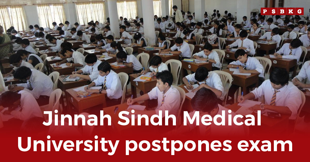 A classroom filled with students in uniform seated at desks, focused on their exams in a bright, well-lit setting, illustrating the news of JSMU exam postponement. JSMU exam postponement.