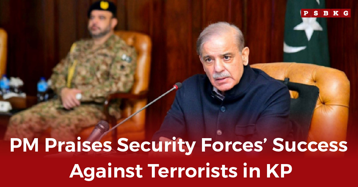 A military official in uniform sits beside a seated official in a suit during a meeting, discussing security successes in KP, as the PM praises security forces for their role.