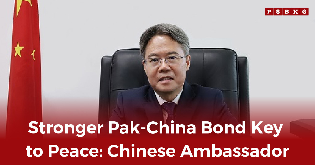 Chinese ambassador seated at a desk with China’s flag in the background, stressing importance of Pak China relations.