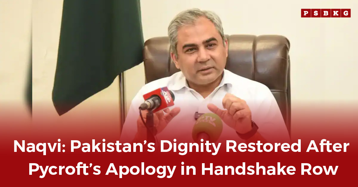 A government official speaks at a press conference with a green flag in the background, addressing a diplomatic incident and Pycroft apology.