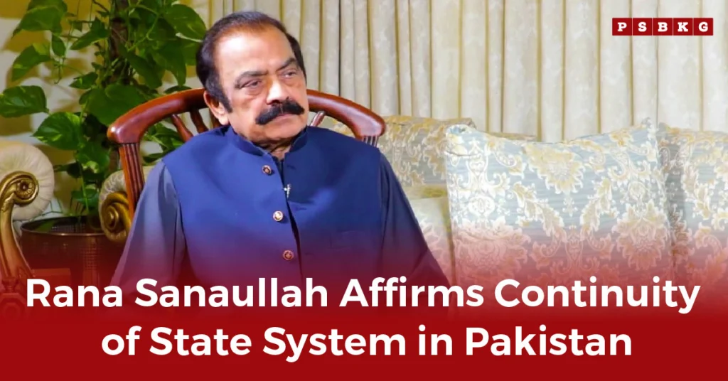 Rana Sanaullah, dressed in traditional attire, sits on a couch discussing the continuity of system Pakistan, with decorative pillows and plants in the background.