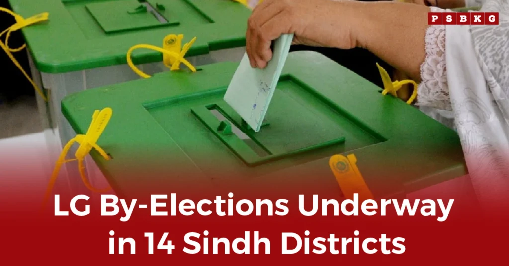 A voter casts a ballot into a green election box during Sindh LG by-elections in Pakistan.