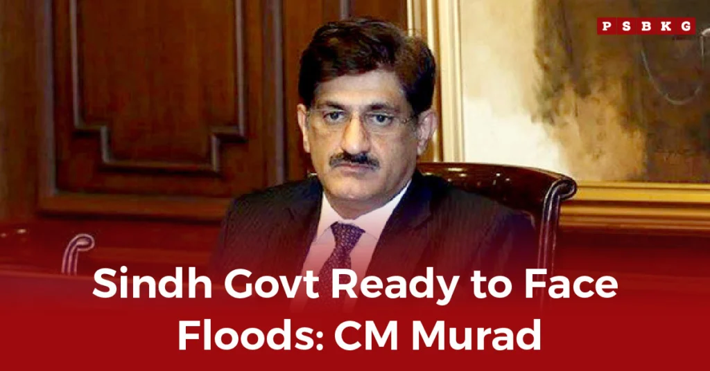 Sindh govt flood preparedness A formal setting with a man in a suit sitting at a desk, discussing flood preparedness for Sindh. Background features wood paneling and artwork.