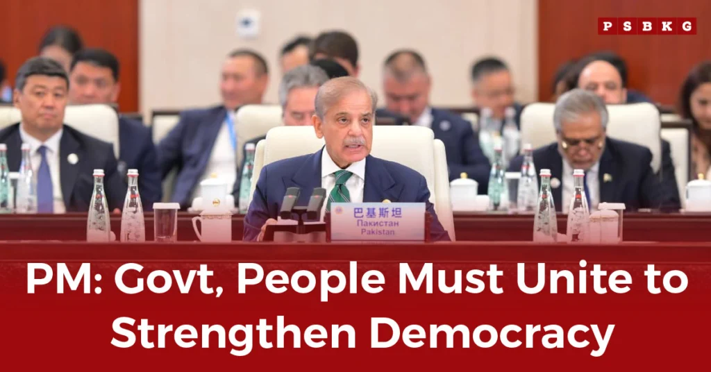 Strengthen Democracy in Pakistan – A conference panel featuring several men in suits seated at a table, with water bottles and microphones present, discussing democracy.