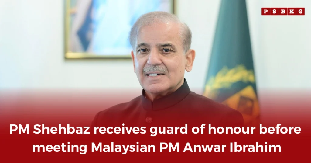 Prime Minister Shehbaz Sharif stands during a formal guard of honour ceremony, with Pakistan and Malaysia’s national flags and an official portrait in the background, symbolizing strong Pakistan Malaysia relations.