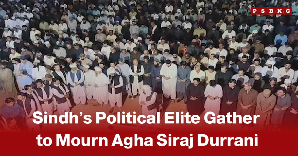 A large gathering of people is shown, with men in traditional attire standing solemnly. The text reads, "Sindh’s Political Elite Gather to Mourn Agha Siraj Durrani," conveying a somber mood. Agha Siraj Durrani funeral.