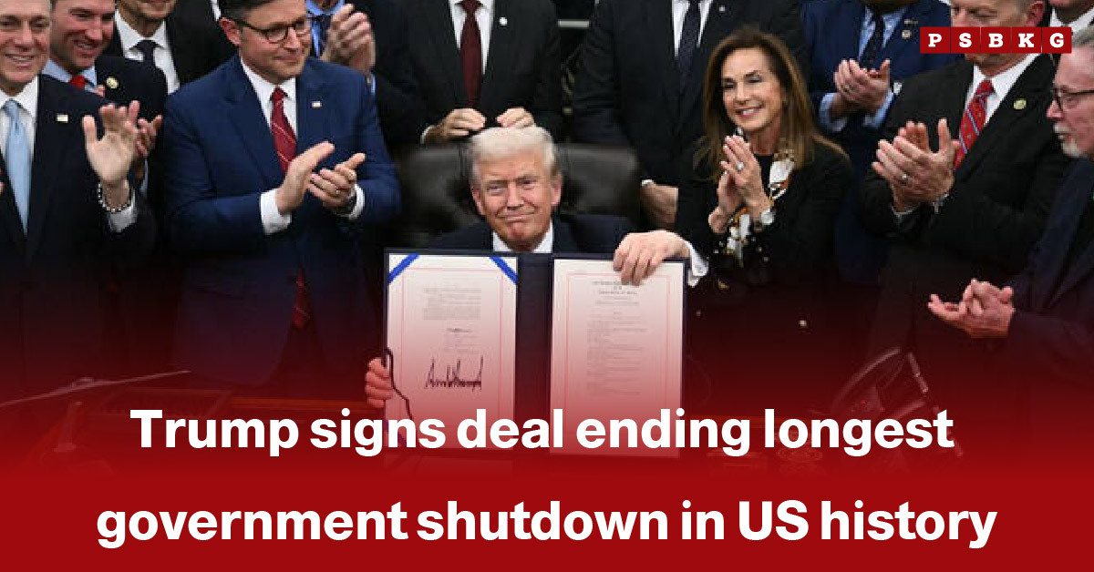 Former President Donald Trump holds signed documents while surrounded by applauding lawmakers at the White House, marking the conclusion of the longest US government shutdown in history.