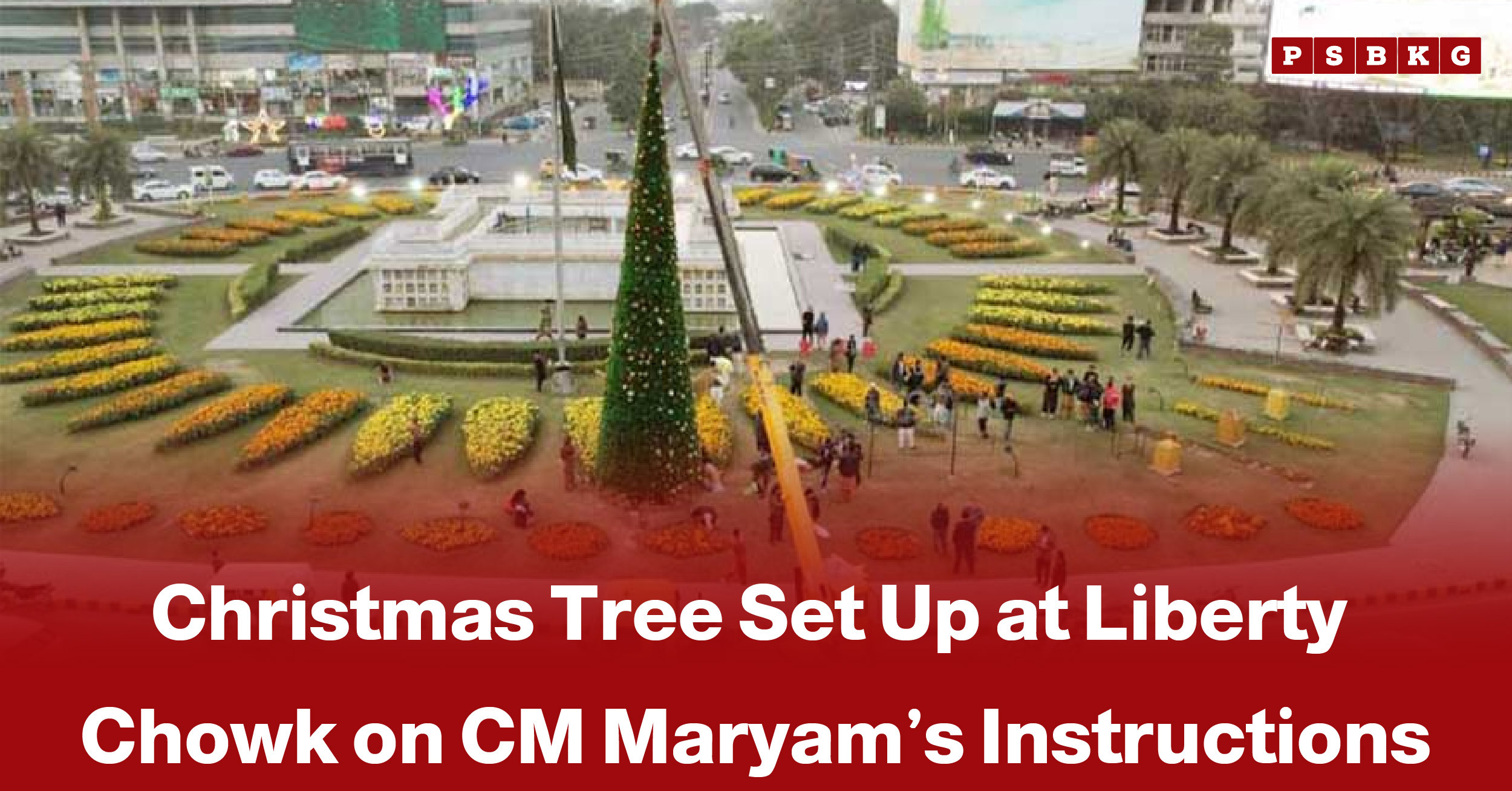 A festive Christmas tree stands tall at Liberty Chowk, surrounded by colorful flower arrangements and onlookers, highlighting Christmas tree Liberty Chowk celebrations.