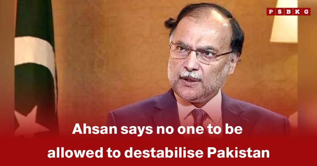Ahsan addresses an audience with the national flag behind him, stressing that no one should undermine Pakistan stability and emphasizing the need to safeguard the country’s political and social coherence.