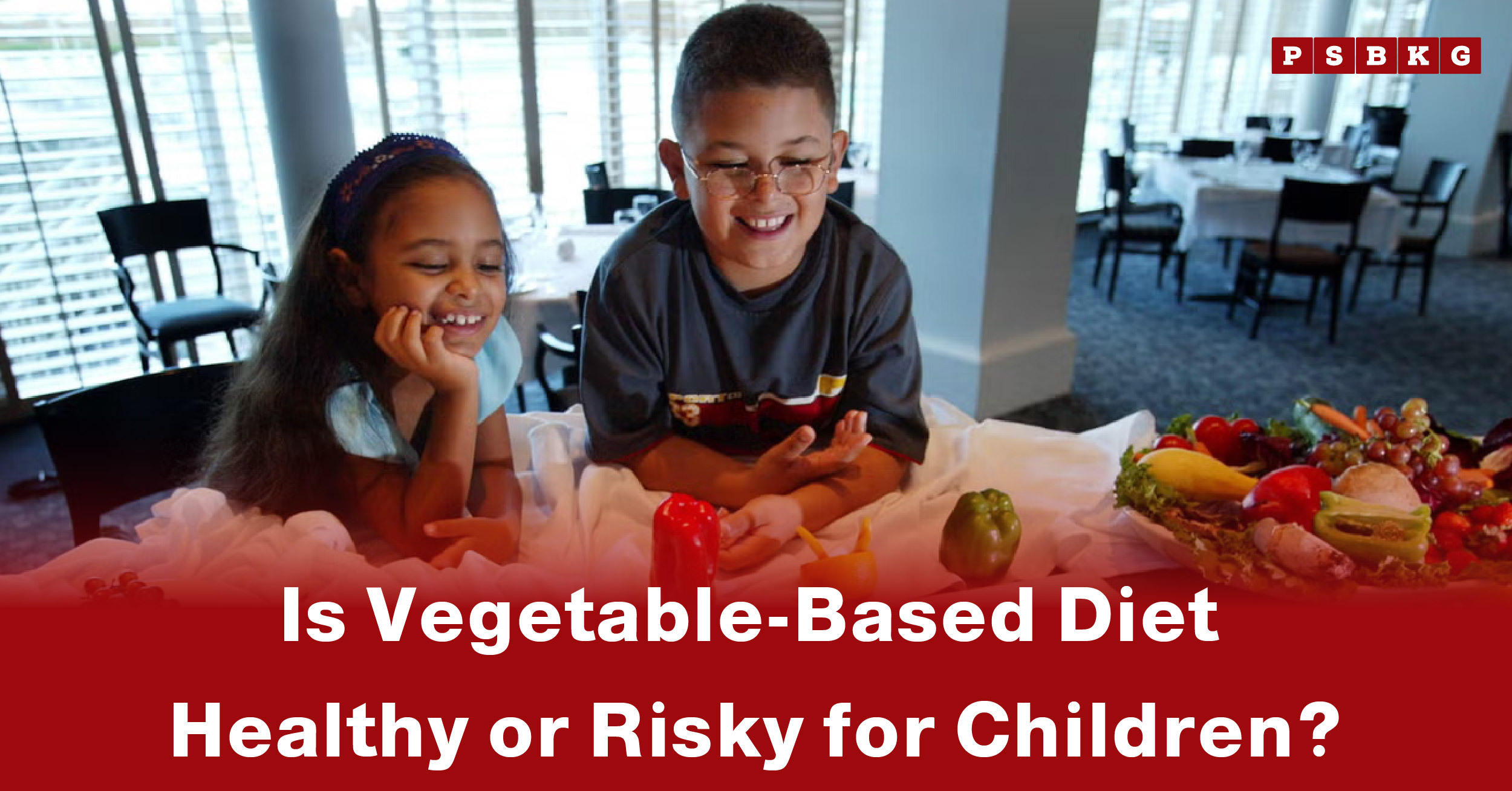 Two children sit at a table with an array of fruits and vegetables, highlighting the effects of a vegetable-based diet for children.