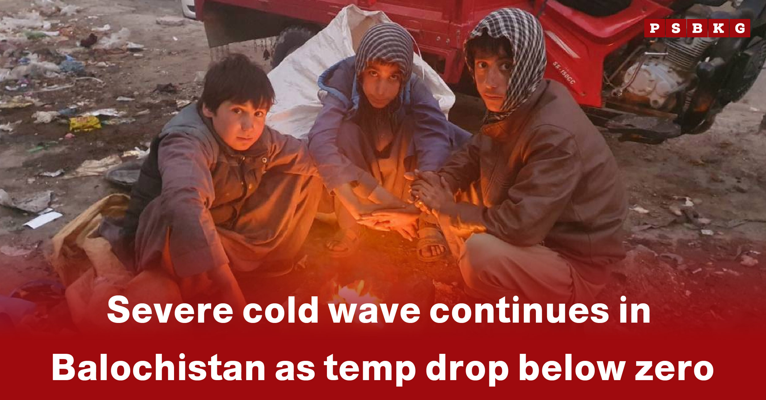Three individuals huddle around a small fire, highlighting the Balochistan cold wave below zero during harsh winter conditions.