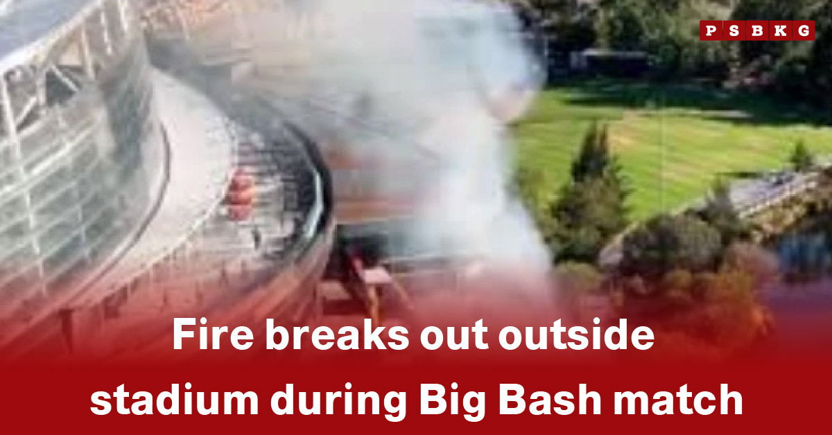 Smoke billows from a fire outside a stadium during a Big Bash cricket match, highlighting the Big Bash stadium fire and concern among spectators.