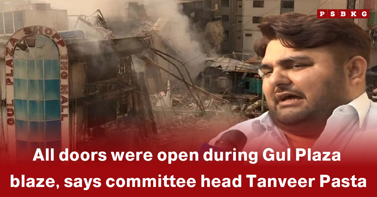 Officials and investigators examine the burnt remains of Gul Plaza during the Gul Plaza fire investigation.