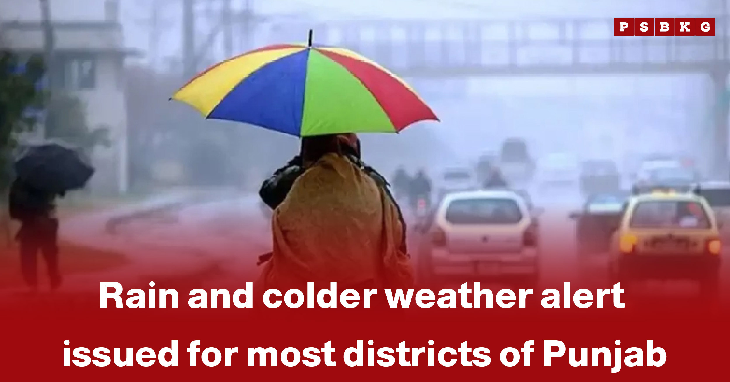 A person with a colorful umbrella walks in the rain amid blurred cars and a misty atmosphere, highlighting Punjab rain and cold weather alert.