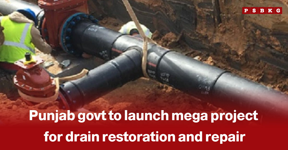 Punjab drain restoration project: Workers install large black drainage pipes in a trench as part of a Punjab government initiative for drain restoration and repair.