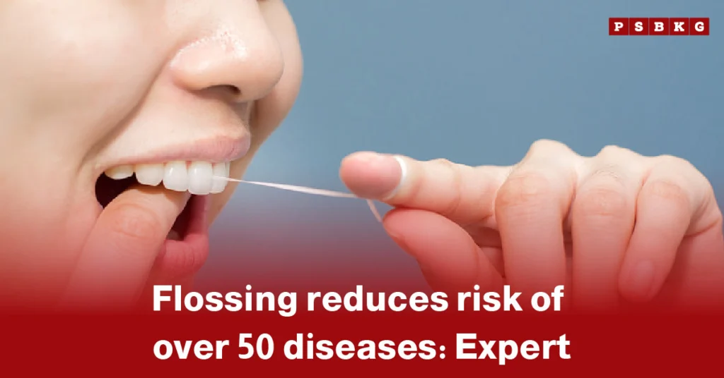 flossing reduces disease risk: Close-up of a hand holding dental floss against a blue background, emphasizing proper dental hygiene.