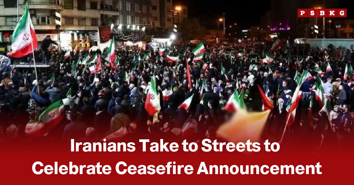 A large crowd gathers at night, waving Iranian flags in the streets as people celebrate the announcement of a ceasefire.