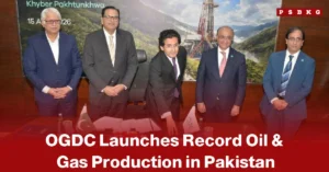 OGDC oil and gas production Pakistan five men in suits pose at a signing event with a backdrop of oil rigs and mountains, celebrating OGDC’s record oil and gas production launch.