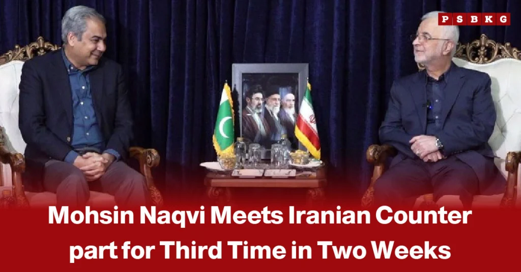 Image of two officials in suits seated on ornate chairs during a diplomatic meeting, with Pakistan and Iran flags displayed on a table between them against a deep blue curtain backdrop, highlighting Mohsin Naqvi’s third meeting with an Iranian counterpart in two weeks.