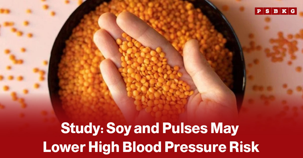 Image of a hand holding orange lentils above a bowl filled with lentils, accompanied by text highlighting research suggesting that soy foods and pulses may help reduce the risk of high blood pressure and support heart health.
