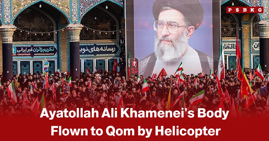 Large crowd carrying Iranian flags gathered outside an ornate religious building, with a prominent portrait of Ayatollah Ali Khamenei displayed above, illustrating funeral proceedings and public mourning in Qom.